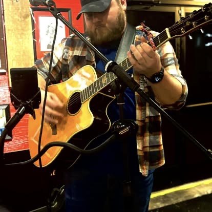 Scotty Sams playing acoustic guitar
